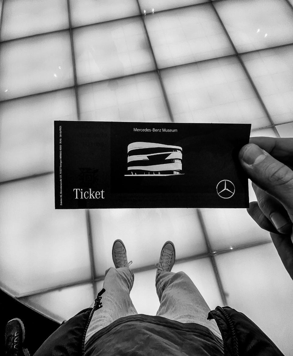 a person holding up a ticket in front of a window